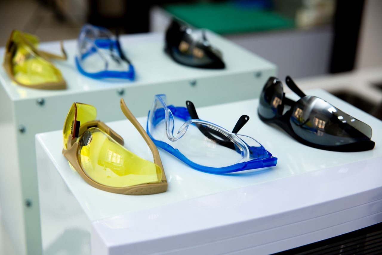 services-img Close-up of different colored protective eyewear on display, featuring yellow, blue, and black designs.